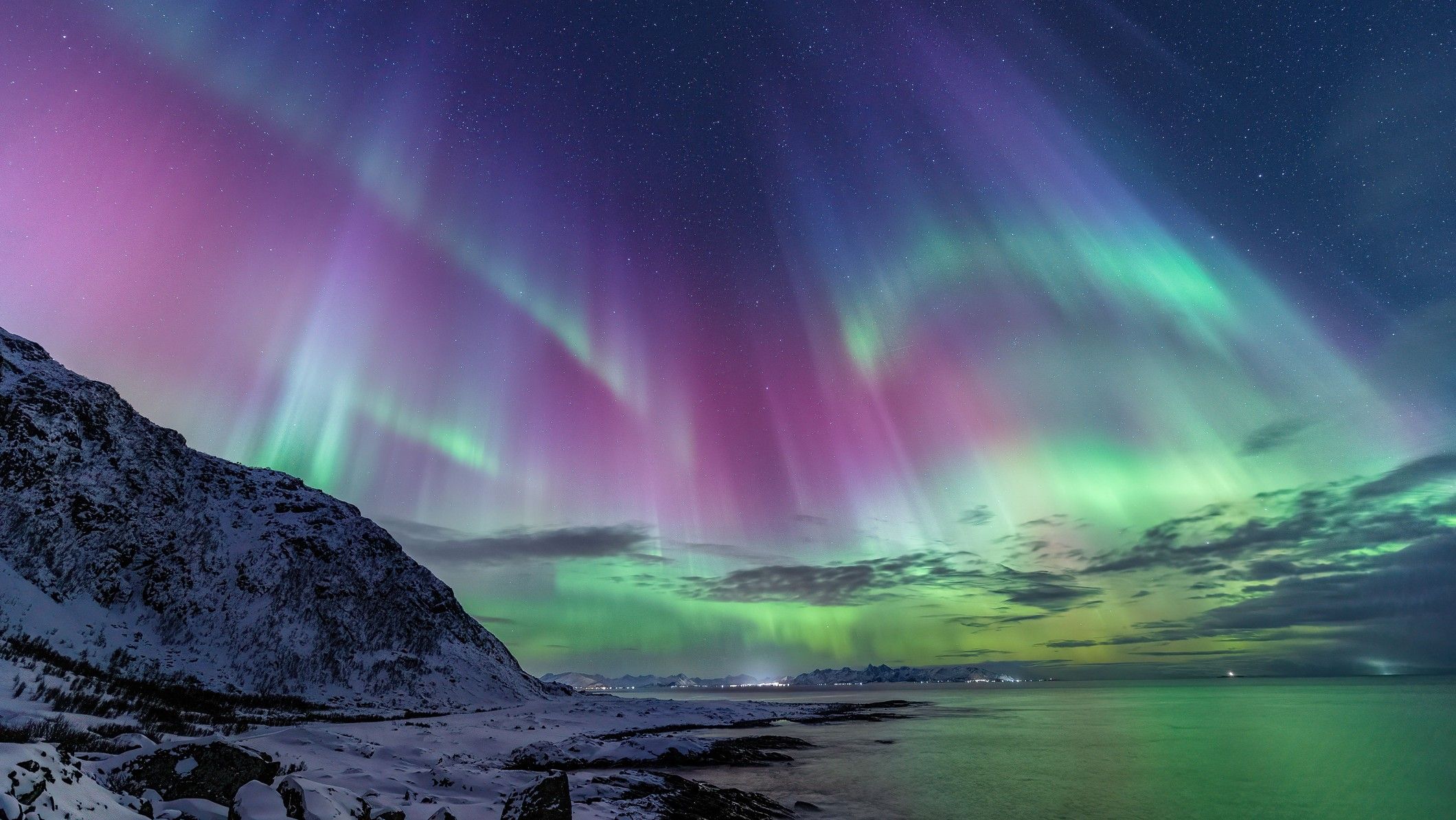 A view of the Northern Lights over an icy landscape in Iceland.